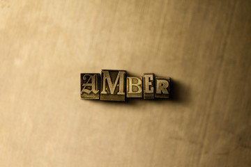 AMBER - close-up of grungy vintage typeset word on metal backdrop. Royalty free stock illustration.  Can be used for online banner ads and direct mail.