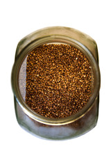 Foodstuff: buckwheat in a glass container over the white background.