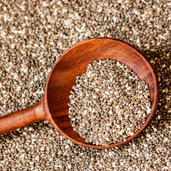 Close up Chia seeds in a wooden spoon. Top view. Concept of detox and healthy eating. For background , backdrop, substrate, composition use. Square