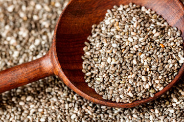 Close up Wooden spoon and Chia seeds. Superfood, healthy concept. For background , backdrop, substrate, composition use.