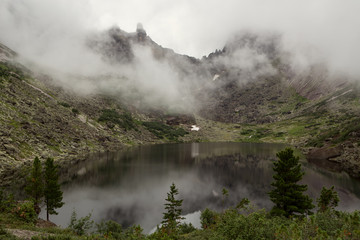 Mountain lake in the fog. Western Sayan. Natural Park Ergaki. Krasnoyarsk region. Russia.
