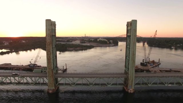 Portsmouth Aerial v15 Flying low over Piscataqua River and Sarah Mildred Long Bridge at sunset.