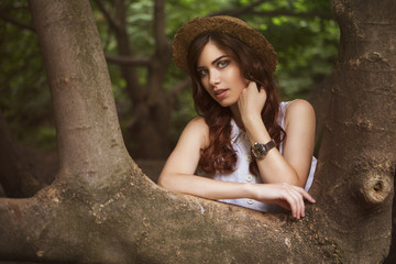 Young beautiful caucasian white brunette woman with curly hairstyle and make up, in a summer...