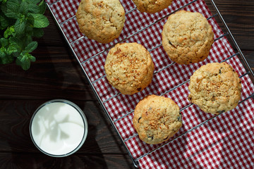 Homemade biscuits with a cup of milk, close view.