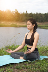 Fototapeta na wymiar Young women pose yoga on nature background