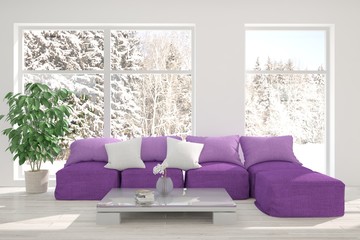 White room with sofa and winter landscape in window. Scandinavian interior design