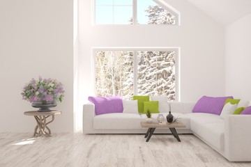 White room with sofa and winter landscape in window. Scandinavian interior design