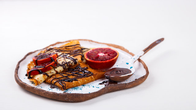 Pancakes with red Orange and Chocolate.Copy space for Text. selective focus.