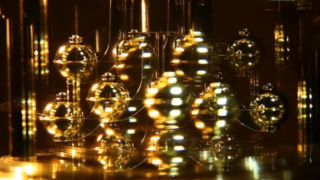 The pendulum clock is reflected in the mirror-based. Gold-plated spinning pendulum clocks.