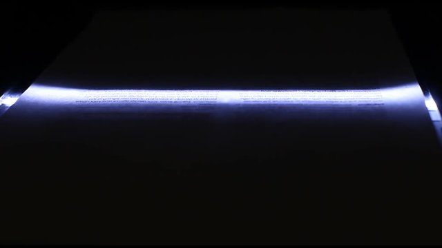 Neon photo scanner lamp moves from top to bottom