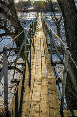 Hanging bridge in countryside. Protva river, Russia