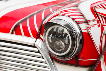 Headlight of vintage tuned vehicle.