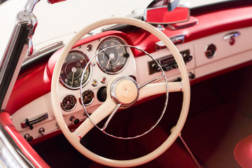 Red control panel of vintage car.