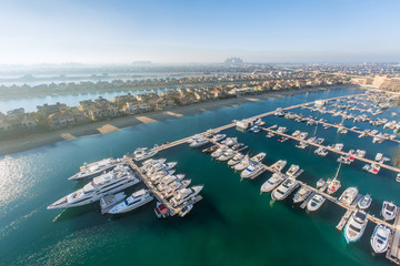 Aerial view of Dubai Palm Island. Villas and yachts landscape.