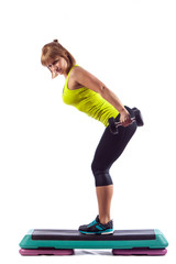 Fitness girl is working out with stepper , isolated on white background