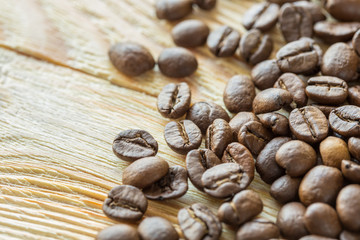 dark brown coffee beans close-up on wooden table