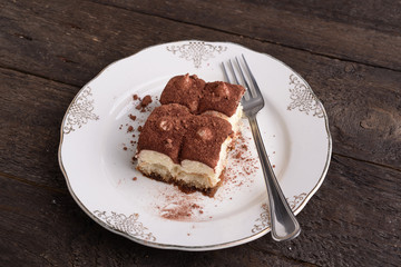 Portion of tiramisu on decorated saucer