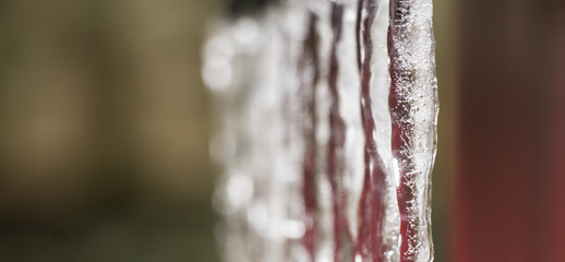 Fototapeta na wymiar Frozen water drops on shed