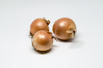 Three onions on white background