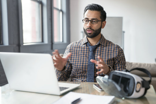 Businessman Using Laptop Computer In Office