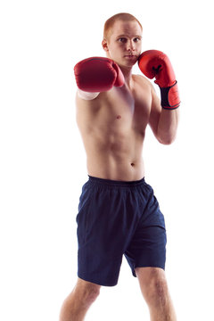 Full length portrait of young male boxer flexing muscles isolated over white background