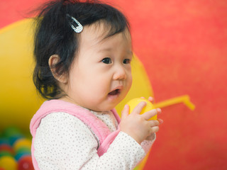 cute smiling baby girl play toy at home