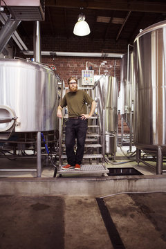 Portrait of confident brewer standing at brewery