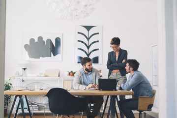 Coworkers discussing in office
