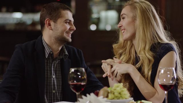 young pair talking at a romantic date in restaurant