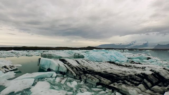The camera sinks at one of the most beautiful natural sights - the ice of Jökulsarlon. It is a large glacial lake in southeast Iceland, on the edge of Vatnajökull National Park.
