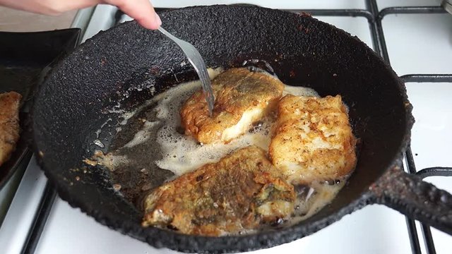 fried cod battered in a cast iron skillet rustic