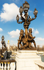 Fototapeta na wymiar The bronze lantern on the bridge of Alexander III in Paris, France