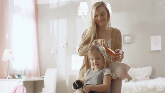 Sweet Young Mother Brushes Hair of Her Cute Little Blonde Daughter. Slow Motion. Shot on RED EPIC-W 8K Helium Cinema Camera.