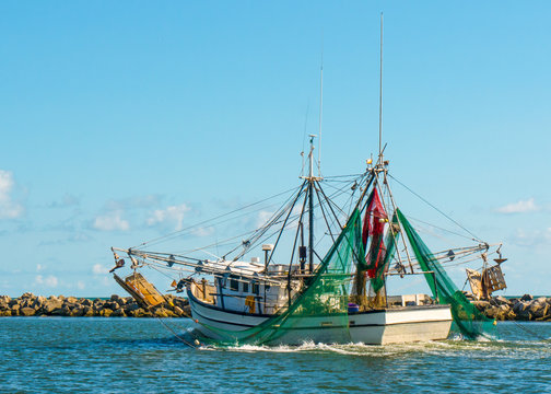 Shrimp trawler fishing boat in Gulf of Mexico near St George Island Florida fishing for seafood