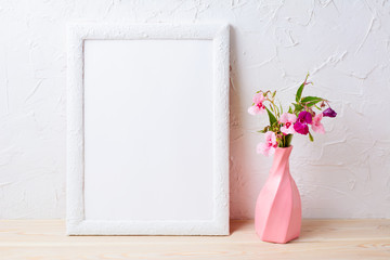 White frame mockup with flowers in swirled pink vase