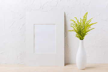 White mat frame mockup with ornamental grass in exquisite vase