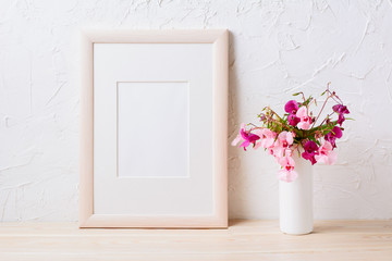 Wooden frame mockup with pink and purple flower bouquet