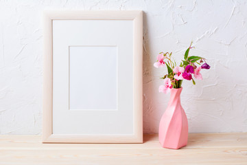 Wooden frame mockup with purple wildflowers in pink vase
