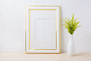 Gold decorated frame mockup with ornamental grass in exquisite vase