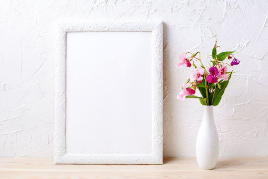 White frame mockup with pink flowers in elegant vase