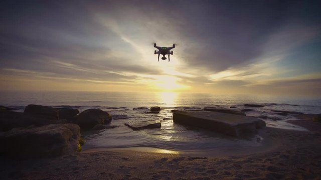 Beautiful sunrise over the sea and flying drone