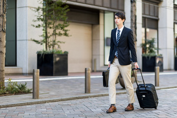 young man walking with a carry bag on the street