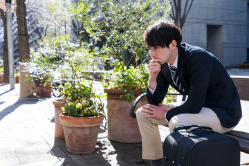 young man sitting on a bench and taking a break