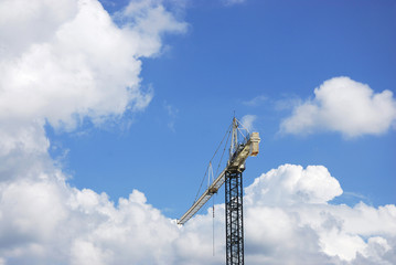 crane in construction site against white cloud and sky