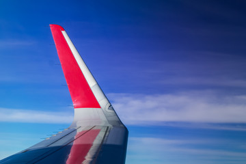 Wing of the plane on blue sky background