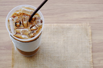 Ice coffee on the brown wood.