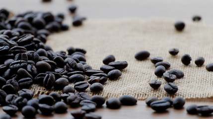 Coffee beans on brown wood.
