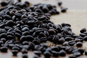 Coffee beans on brown wood.