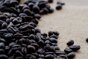 Coffee beans on brown wood.