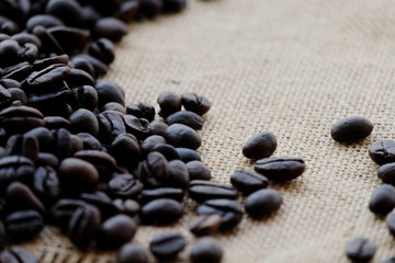 Coffee beans on brown wood.